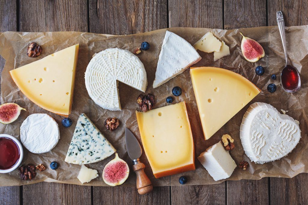 various types of cheese on rustic table top view various types of cheese on rustic table top view